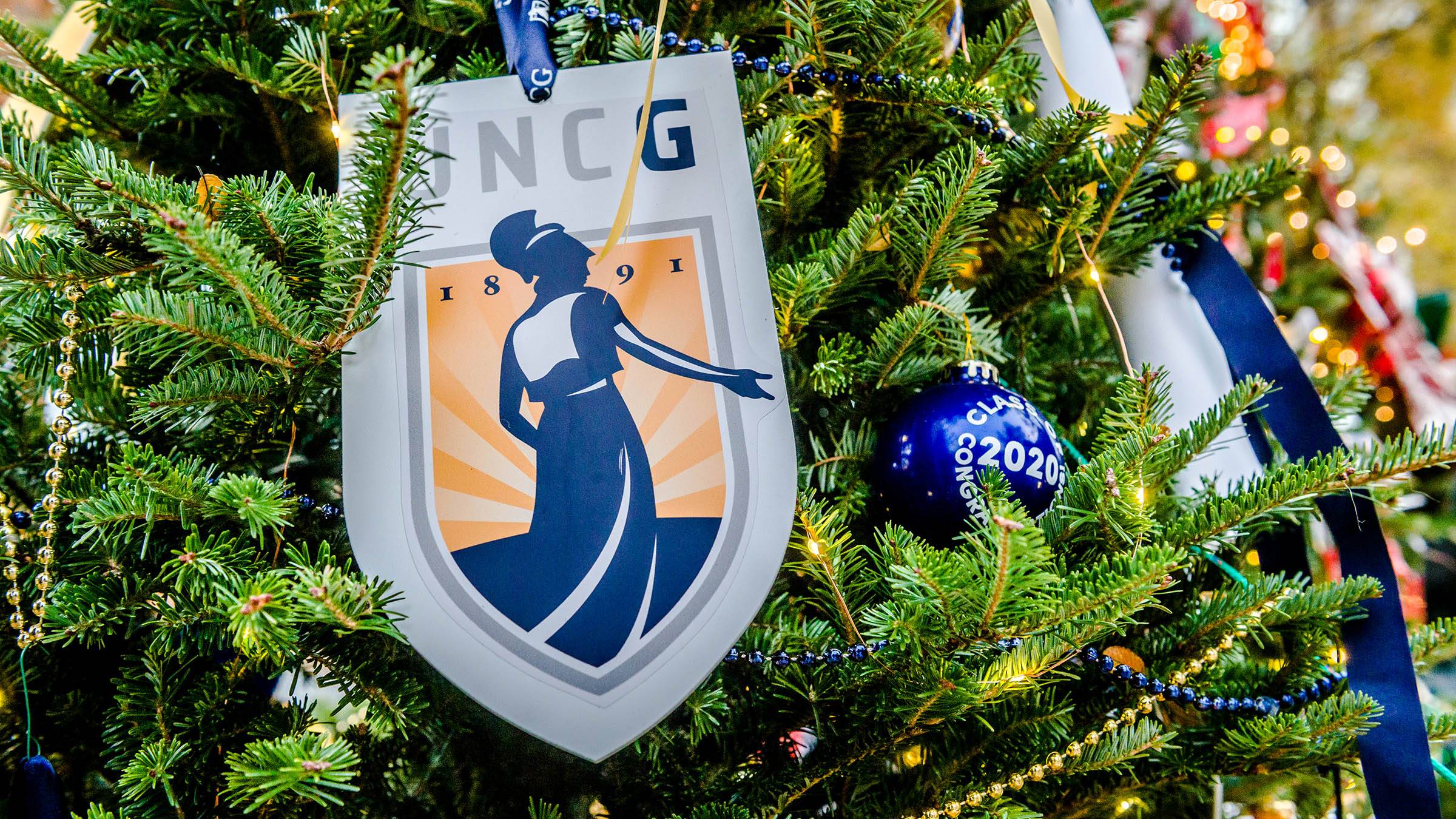 A UNCG emblem on a Christmas tree.