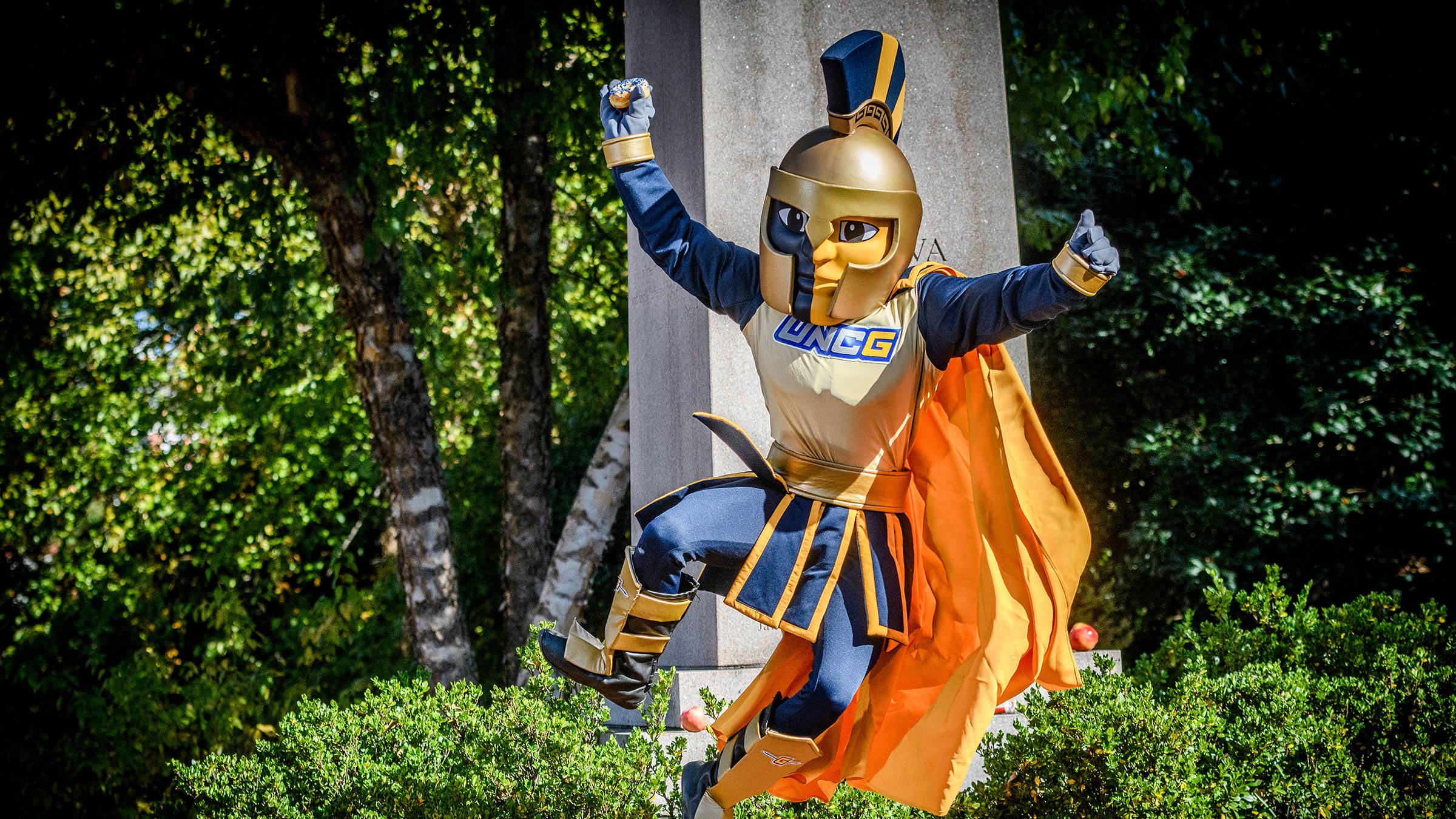 UNCG's mascot, Spiro, jumping in joy.