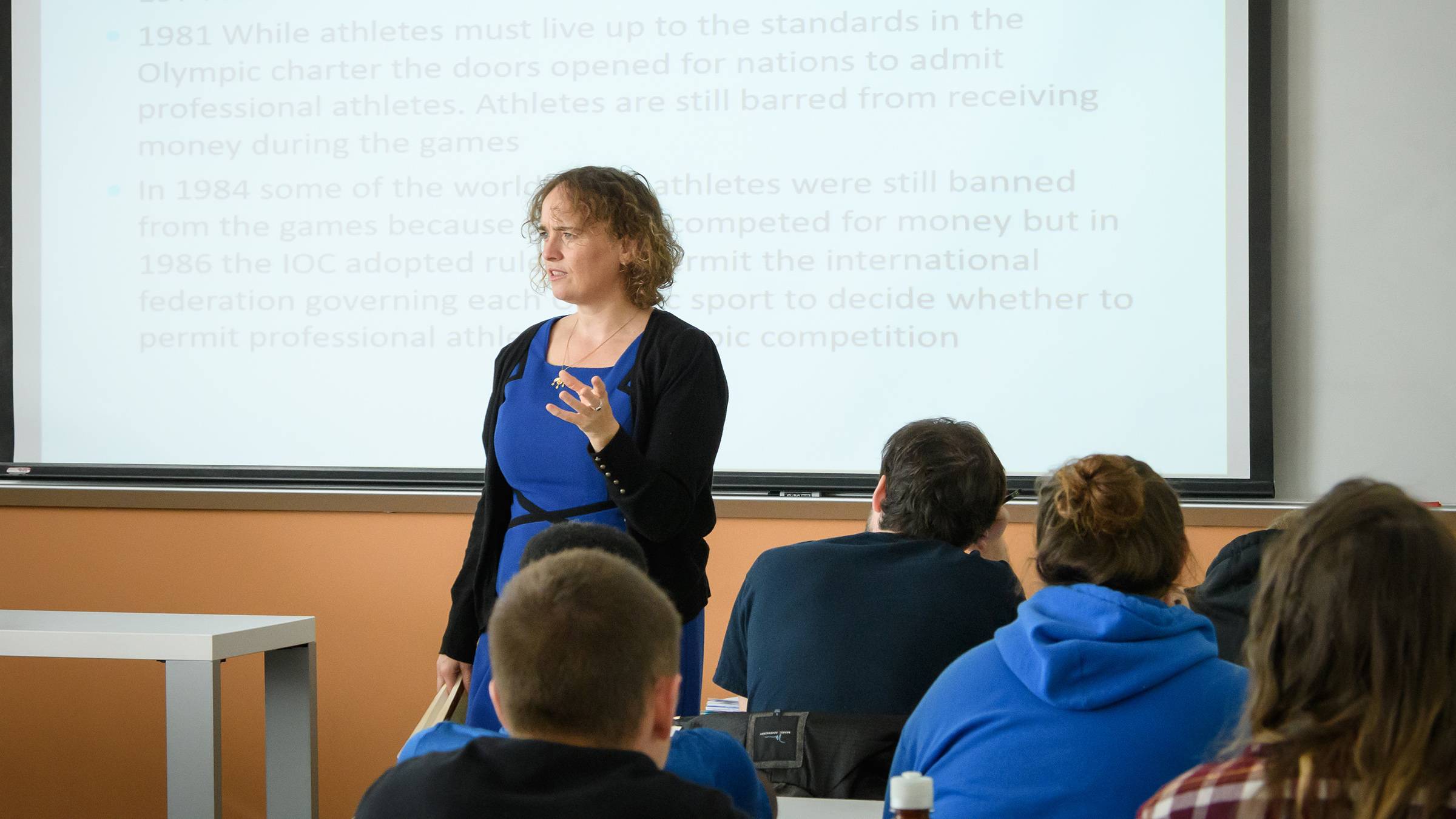 A uNCG professor teaching in a classroom.