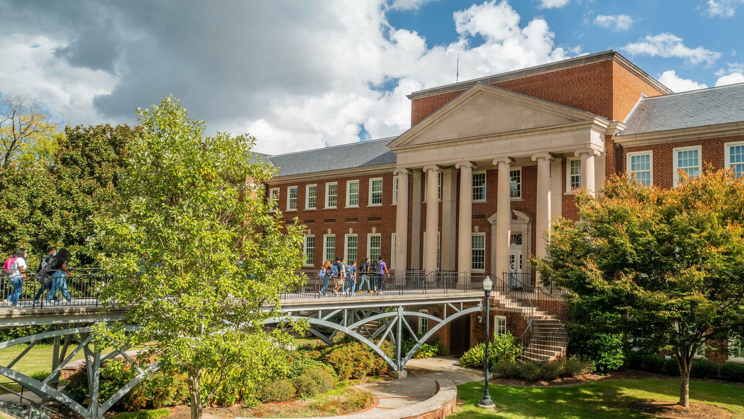 Students walking on the pedestrian bridge leading to the Sullivan Science Building.