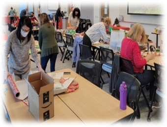 staff wrapping presents at the 2021 wrap party