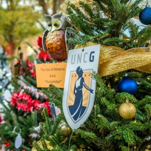 A UNCG emblem on a Christmas tree.