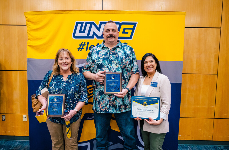 Staff Excellence Award winners (Mitzi Lorenz and Andrew Holladay) and the Gladys Strawn Bullard staff award winner (Margarita Kerkado) holding their plaques and certificates.