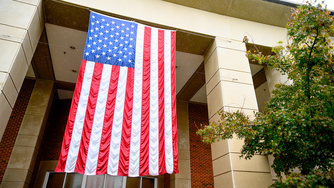 United States flag hanging from building