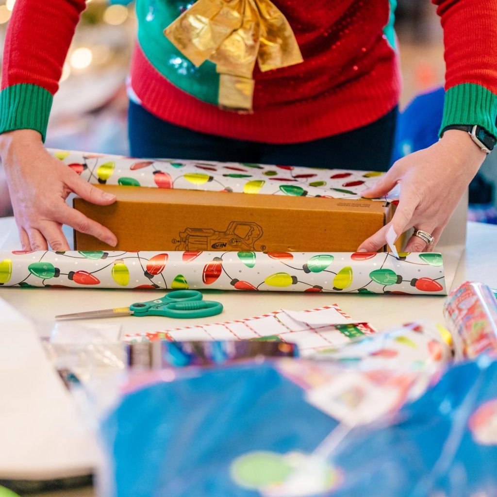 wrapping a present in holiday paper