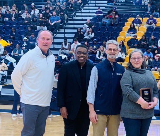 Jessica Quattrucci receiving SoCon Staff Award at UNCG Basketball Game.